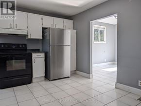 Oshawa (Samac) apartment for rent - A kitchen with a black oven and a white dishwasher.