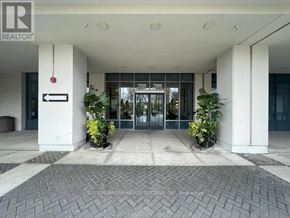 Vaughan (Beverley Glen) condo for rent - The image shows the front entrance of a building with a glass door and a sign that reads "REALTOR".