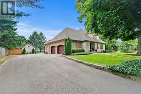 Niagara-On-The-Lake (Queenston) apartment for rent - A large, well-maintained house with a driveway in front.