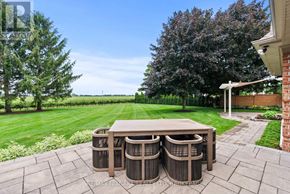 Niagara-On-The-Lake (Queenston) apartment for rent - A backyard with a table and chairs set up.