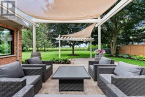 Niagara-On-The-Lake (Queenston) apartment for rent - A patio with grey couches and a table under a white canopy.