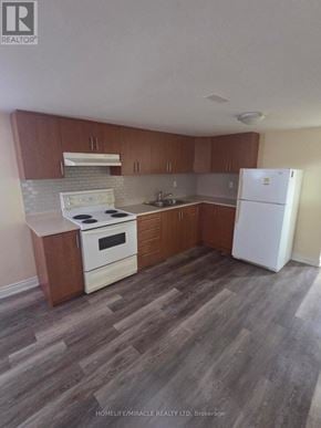 Brampton (Brampton East) apartment for rent - A kitchen with wooden cabinets and a white fridge.