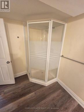 Brampton (Brampton East) apartment for rent - A white door with a glass panel is in a room with wood flooring.