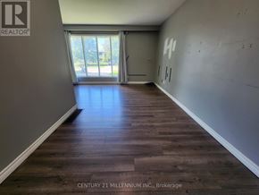 Orangeville apartment for rent - A room with wooden floors and a window with a view of a park.