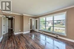 Thorold (Thorold Downtown) apartment for rent - A room with wooden floors and a large window.