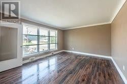 Thorold (Thorold Downtown) apartment for rent - A room with wooden flooring and a large window.
