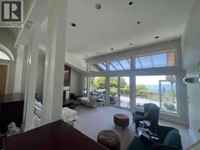West Vancouver apartment for rent - A living room with a couch, chairs, and a table with a view of the outdoors.