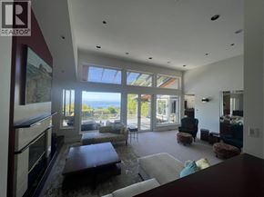 West Vancouver apartment for rent - A living room with a large window and sliding glass doors.