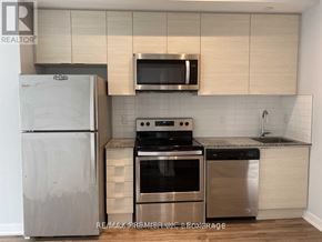 Toronto (Bayview Village) condo for rent - A kitchen with a stainless steel refrigerator, microwave, oven, and dishwasher.