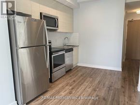 Toronto (Bayview Village) condo for rent - A kitchen with a stainless steel refrigerator, microwave, and oven.