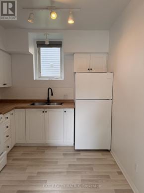 Russell apartment for rent - A kitchen with white appliances and cabinets.