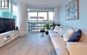 Toronto (Lansing-Westgate) condo for rent - A living room with a couch, television, and a large window.
