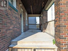 Oshawa (O'neill) apartment for rent - A wooden deck leads to a door with a window.