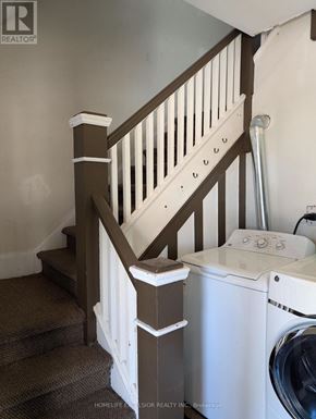 Oshawa (O'neill) apartment for rent - A washer and dryer are tucked under a staircase.