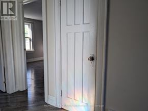 Oshawa (O'neill) apartment for rent - A white door with a silver handle is in the foreground of the image.