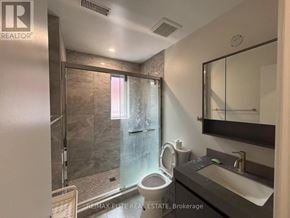 Toronto (Mimico) apartment for rent - A bathroom with a toilet, sink, and shower.