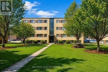 Burlington (Brant) condo for rent - A building with the text RE/MAX EXCEL TITAN Brokerage on it.