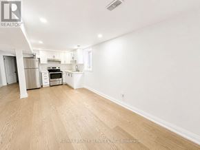 Brampton (Heart Lake West) apartment for rent - A spacious room with wooden flooring and white walls.