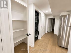 Brampton (Heart Lake West) apartment for rent - A white kitchen with a refrigerator and a washing machine.