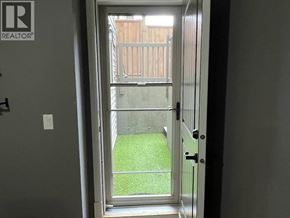Maple Ridge apartment for rent - A doorway with a glass door leading to a backyard.