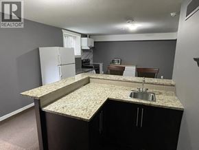 Maple Ridge apartment for rent - A kitchen with a granite countertop and a sink.