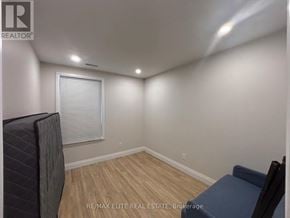 Toronto (Mimico) apartment for rent - A room with a window covered by blinds and a wooden floor.