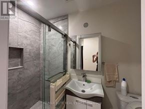 Toronto (Mimico) apartment for rent - A bathroom with a sink, mirror, and toilet.