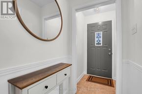 Ottawa apartment for rent - A hallway with a grey door and a wooden bench.