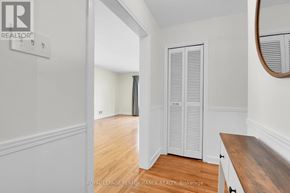 Ottawa apartment for rent - A white room with a wooden floor and a white wardrobe.