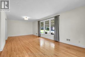 Ottawa apartment for rent - A room with wooden flooring and a sliding glass door.