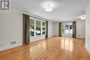 Ottawa apartment for rent - A spacious room with wooden floors and sliding glass doors.