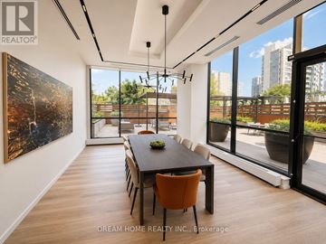 Toronto (North St. James Town) condo for rent - A modern dining room with a large table and chairs.