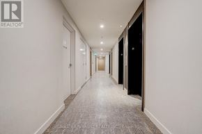 Toronto (Banbury-Don Mills) condo for rent - A long hallway with doors on both sides and a carpeted floor.