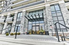 Markham (Unionville) condo for rent - A modern building with a stone facade and a glass entrance.