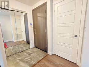 Markham (Unionville) condo for rent - A hallway with a wooden door and a white door with a glass panel.