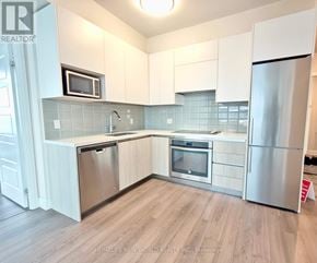 Markham (Unionville) condo for rent - A kitchen with white cabinets and stainless steel appliances.