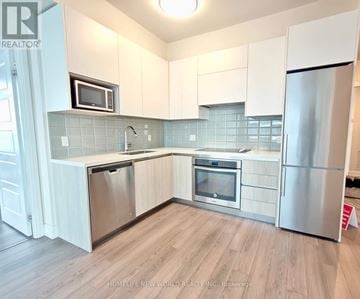 Markham (Unionville) condo for rent - A kitchen with white cabinets and stainless steel appliances.