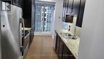Mississauga (City Centre) condo for rent - A kitchen with a stainless steel refrigerator and a sink.