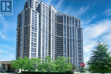 Toronto (West Humber-Clairville) condo for rent - A tall residential building with a sign that says "STOP" in front of it.