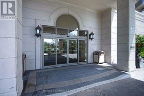 Toronto (West Humber-Clairville) condo for rent - The entrance to a building with a glass door and a sign that reads "REALTOR".