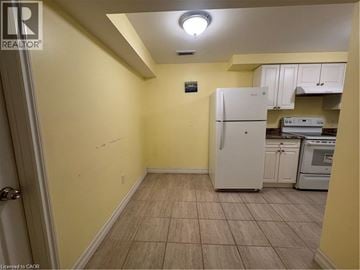 Cambridge apartment for rent - A kitchen area with a white refrigerator and a white oven.
