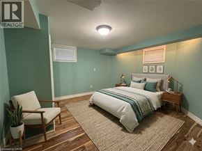 Cambridge apartment for rent - A bedroom with a bed, nightstand, chair, and plant.