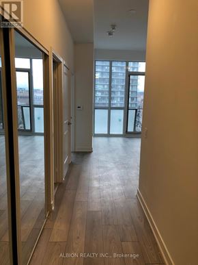 Toronto (Moss Park) condo for rent - A hallway with wood floors and white walls.