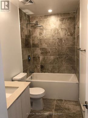 Toronto (Moss Park) condo for rent - A bathroom with a toilet, sink, and bathtub.