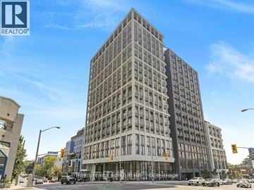 Toronto (Humewood-Cedarvale) condo for rent - A tall building with many windows is the main focus of the image.