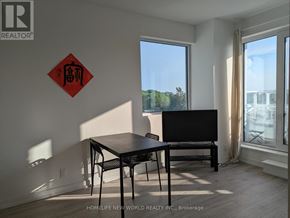Toronto (Humewood-Cedarvale) condo for rent - A black table and chairs in a room with a red sign on the wall.