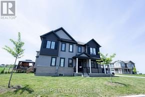 Ottawa apartment for rent - A large house with a grey exterior and a black roof.