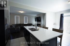 Ottawa apartment for rent - A kitchen with a white countertop and black chairs.