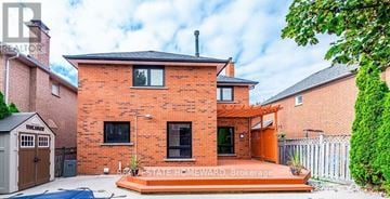 Newmarket (Gorham-College Manor) apartment for rent - A red brick house with a white fence and a small garden.