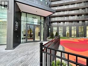 Toronto (Clanton Park) condo for rent - A building with a red and orange patterned area in front of it.